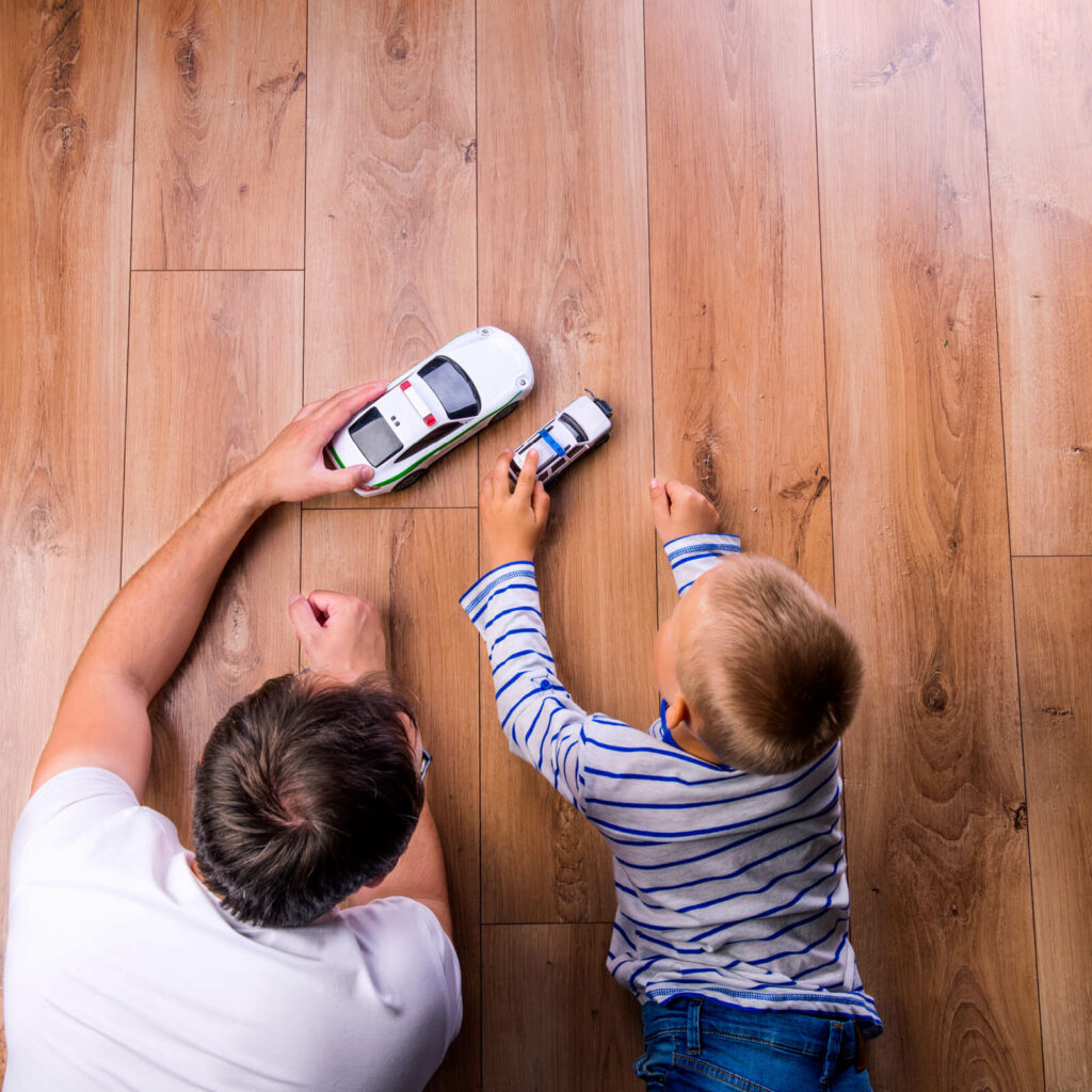 Father son play toy car | McCools Flooring