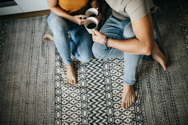 Couple sitting on rug | McCools Flooring