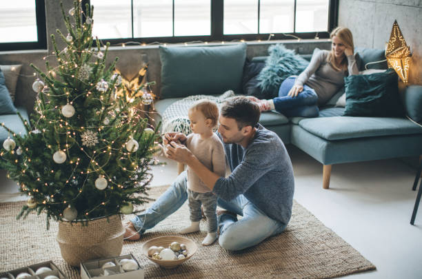 Father and daughter decorate a christmas tree | McCools Flooring